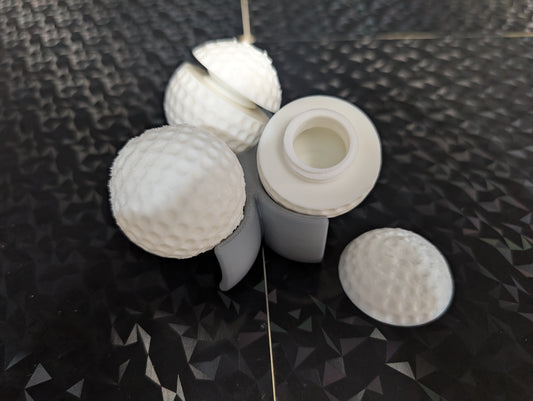 3 Gilmore golf balls with ball holder