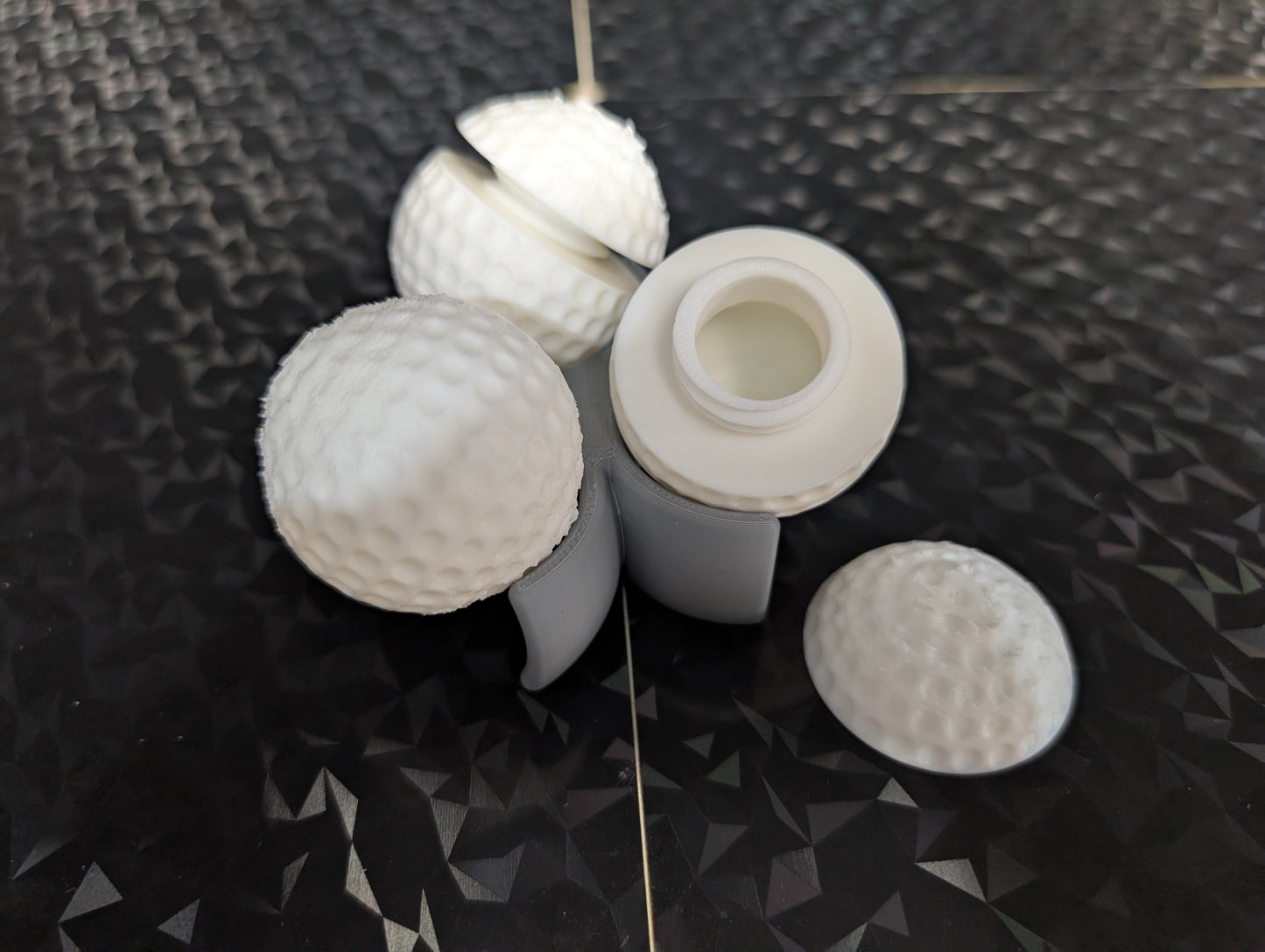 3 Gilmore golf balls with ball holder